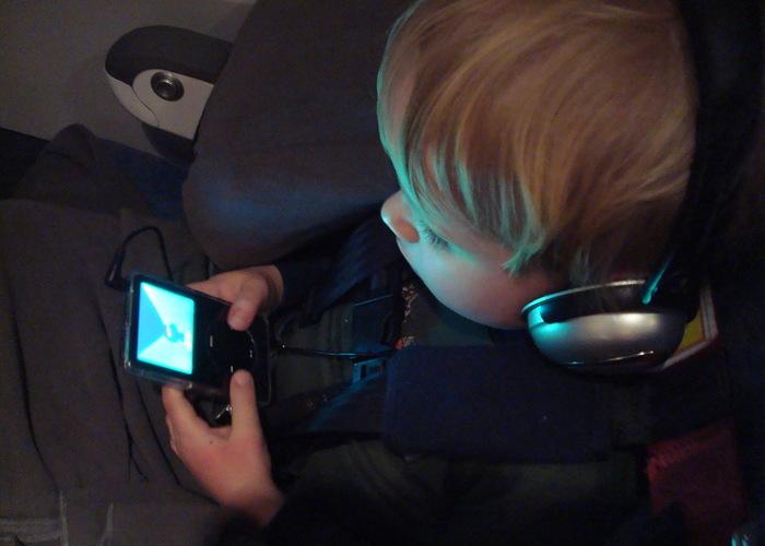 Boy using an iPod with helmets